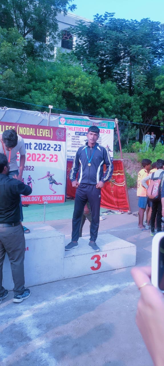 CDGI Athlete standing on the 3rd place podium with a medal at RGPV Athletics Meet.