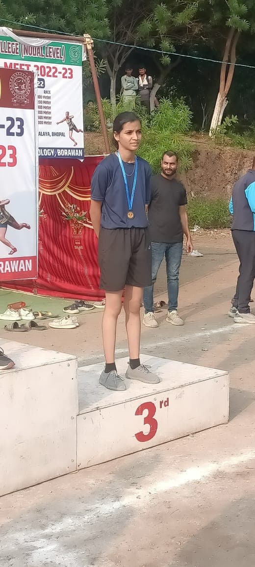 CDGI athlete standing on the podium at the RGPV Nodal Level Athletics Meet.