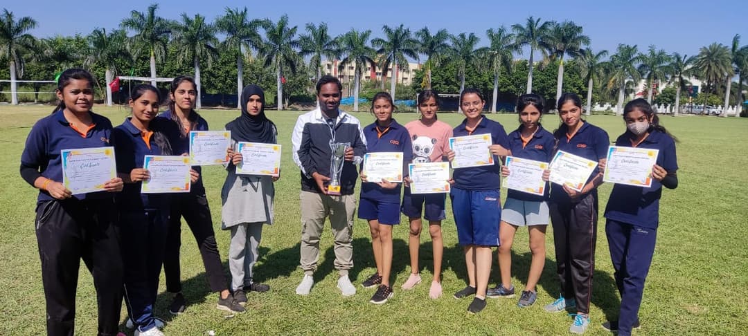 CDGI Girls Volleyball team celebrating their victory on the sports field.