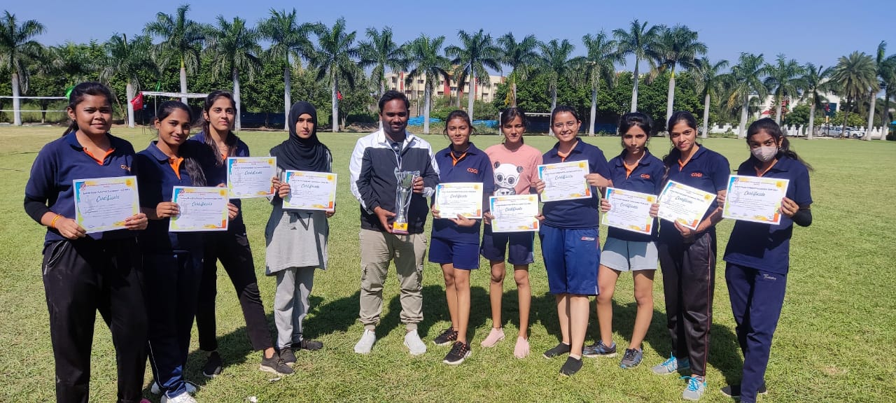 CDGI Girls Volleyball team celebrating their victory on the sports field.